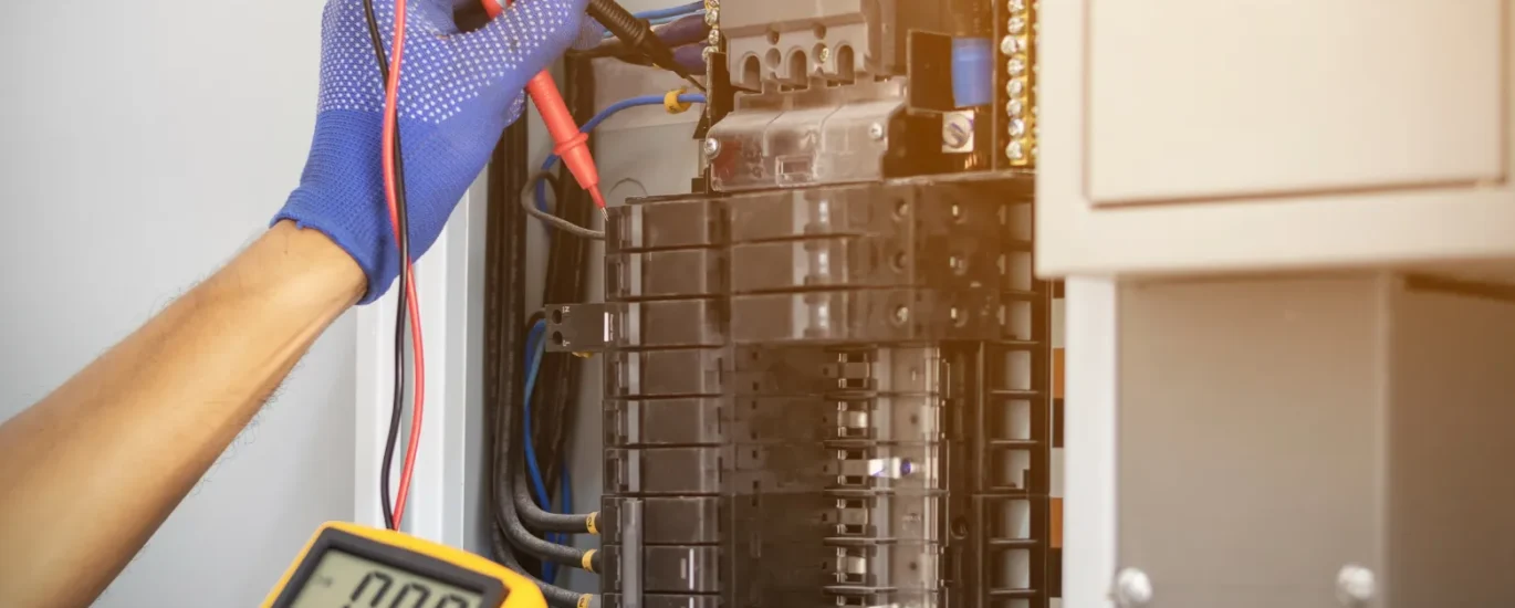 Licensed electrician inspecting an electrical panel in a Sacramento home