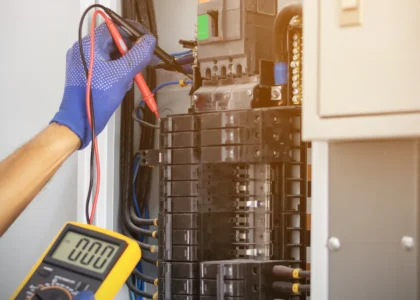Licensed electrician inspecting an electrical panel in a Sacramento home