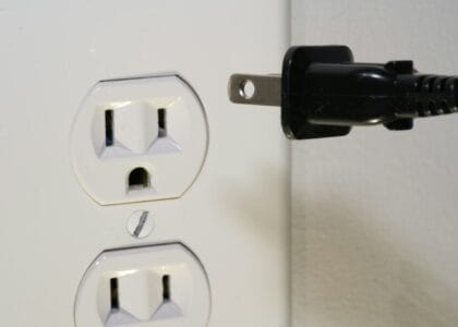 black male plug in front of electric socket