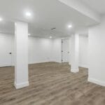 an empty room with white walls and wooden floors